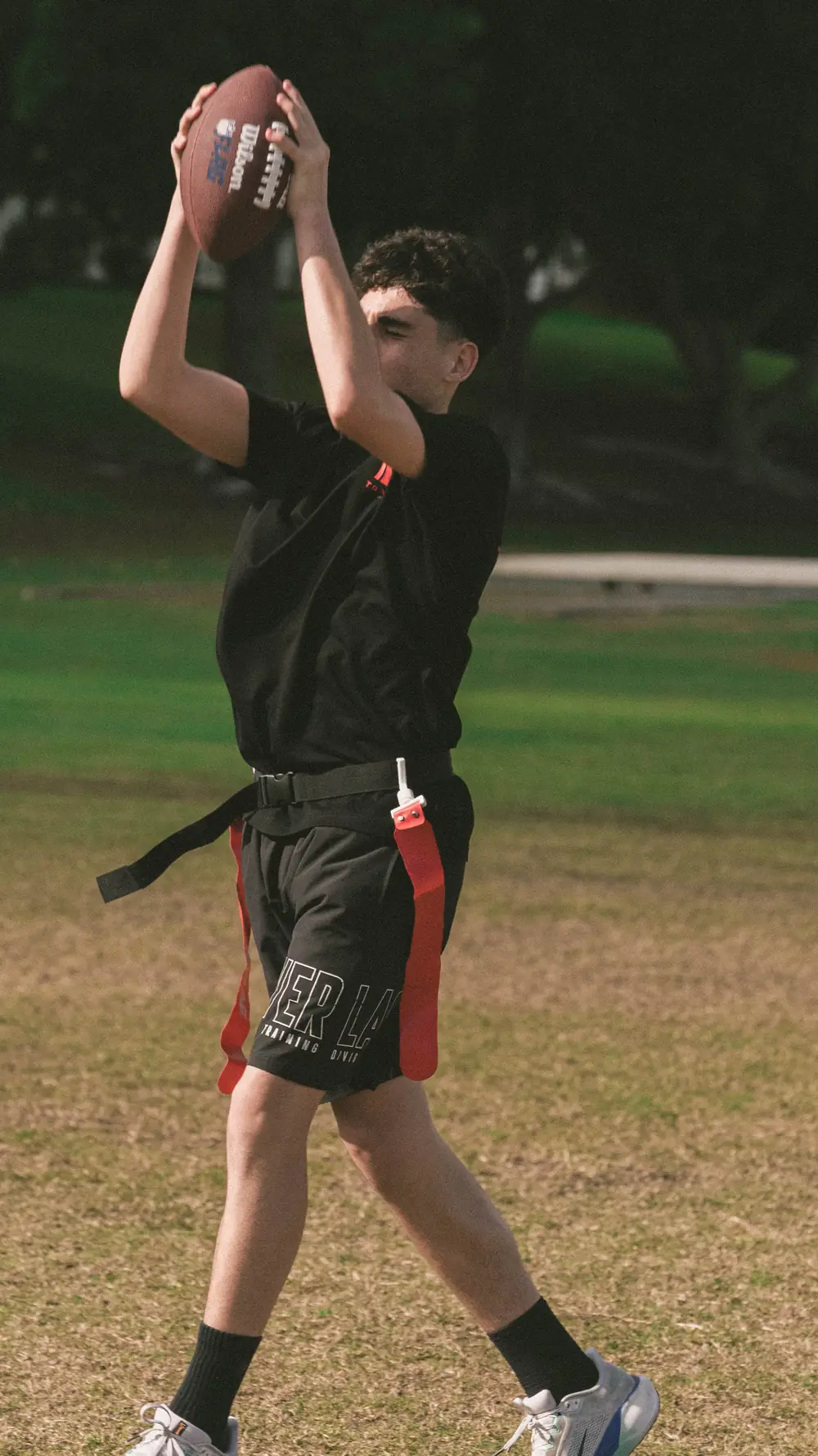 A young player leaping to catch a pass at a TRAILS Touchdown session