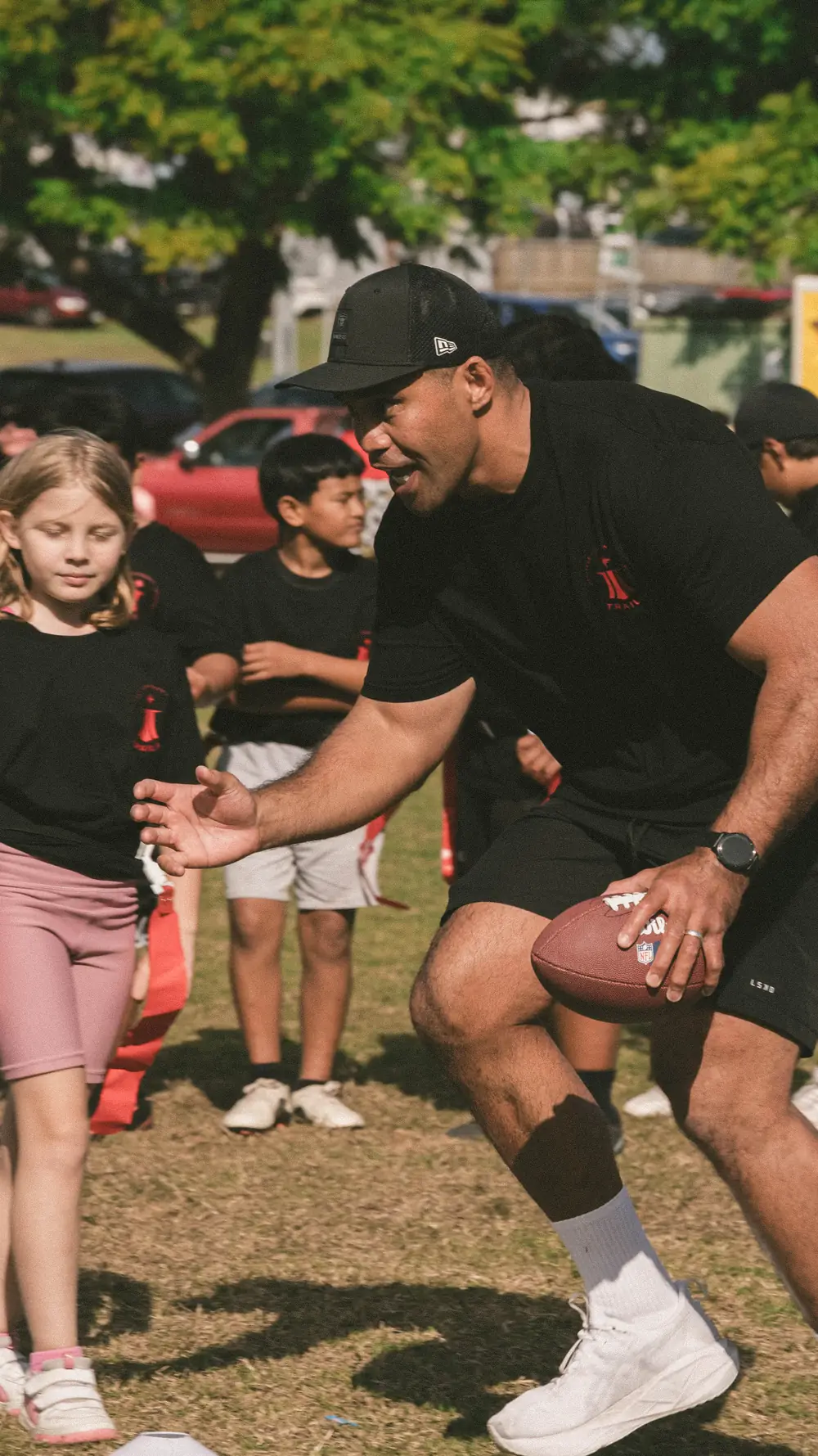 A TRAILS coach running a drill with younger players