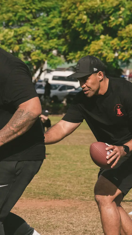 A coach handing the ball off during a drill